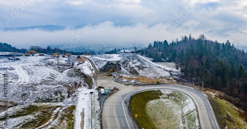 Aerial drone view on winter road construction in Polish Beskidy mountains