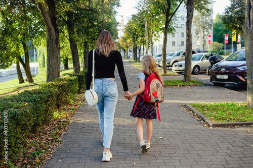 preschool girl walk with her mother