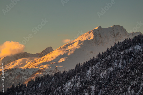 Winter setting in swiss alps above the valley of Brig, viewed from the Simplon pass in early evening at sunset © Anze