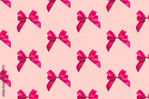 Pink bows pattern on pink background. Gift wrapping