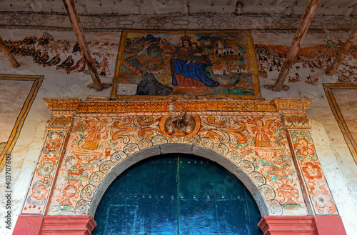 Fototapeta Entrance of the colonial church of Chinchero with its fresco paintings mural, Sacred Valley of the Inca, Cusco province, Peru