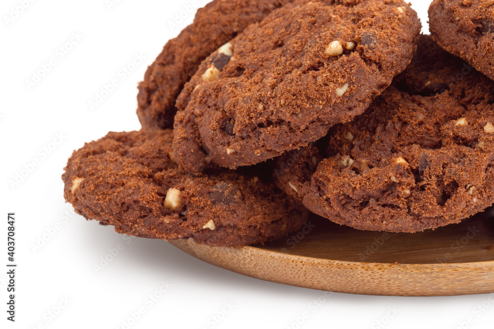 Fototapeta premium rich round cookies with nuts and chocolate, lying on a wooden plate, isolate on a white background