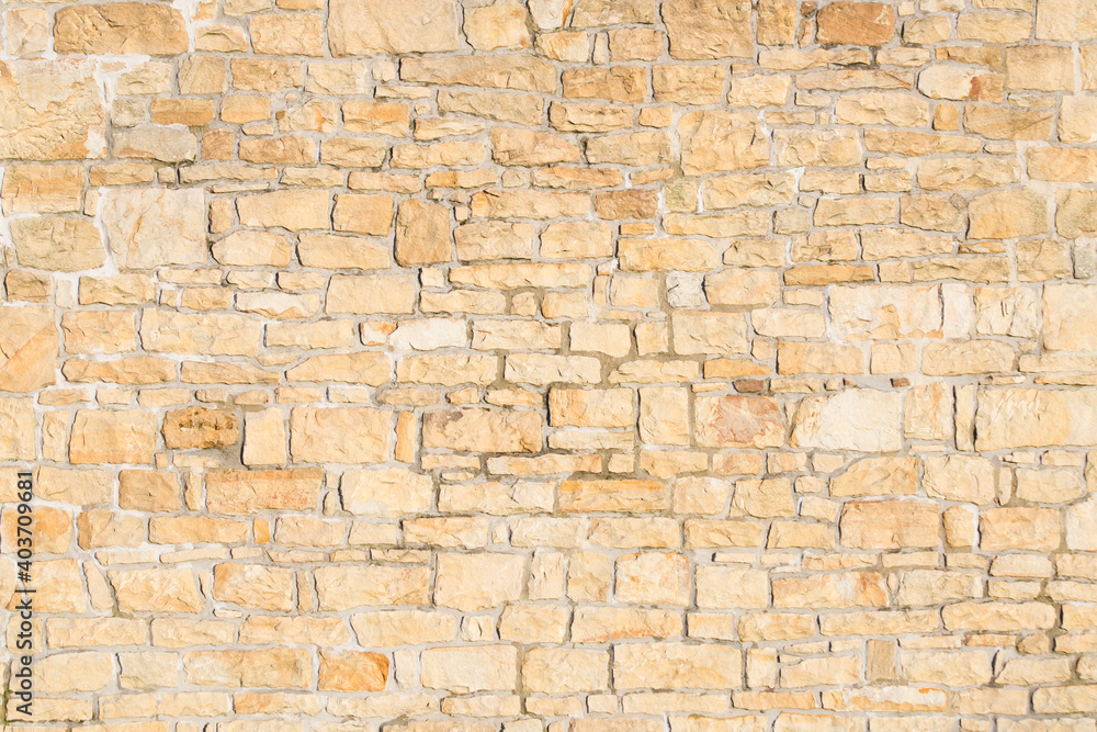 old sandstone wall stacked and placed with cement. stone background. copy for space and text.