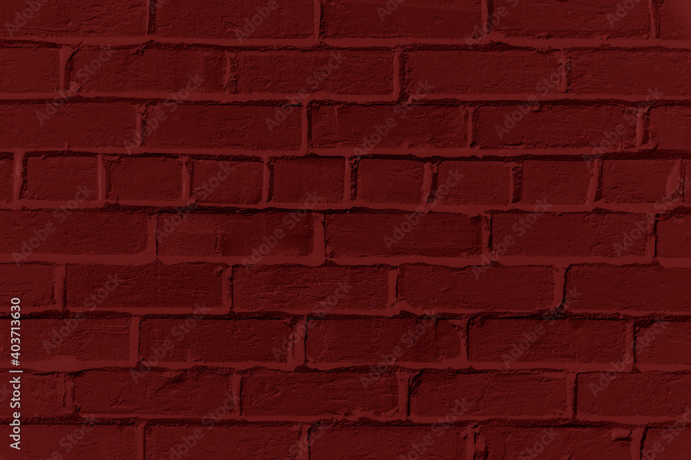 Fototapeta premium Red brick wall background. Monotone texture of a flat brick wall close-up.