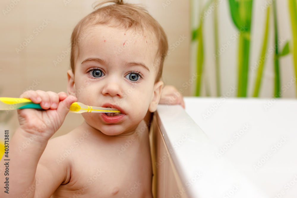 Baby boy brushes teeth in bathroom. Concept of oral hygiene. Baby boy brushes teeth in bathroom. Concept of oral hygiene.