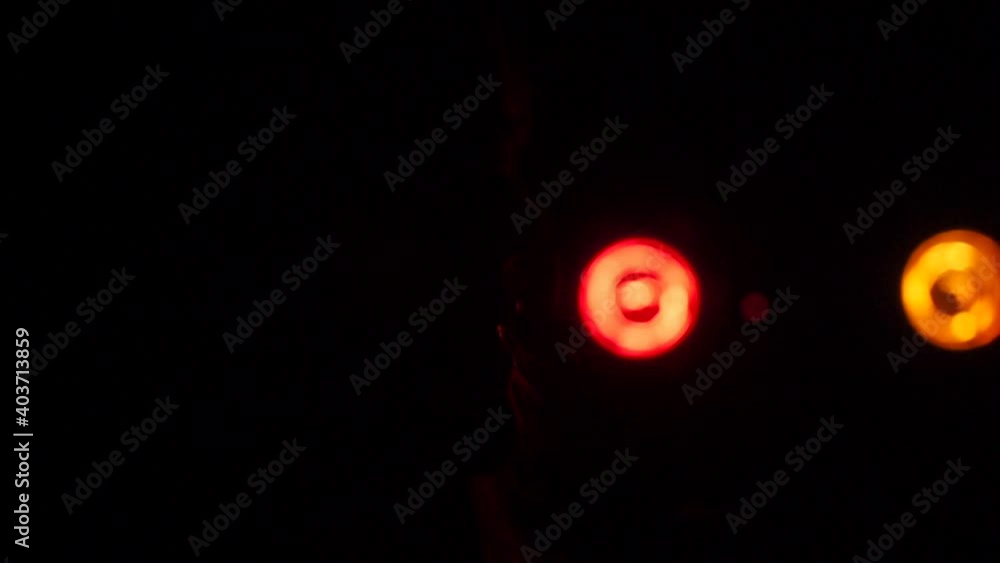 A shot of a silhouette of a singing woman with blinking colored lights in slow motion. A shot of a silhouette of a singing woman with blinking colored lights in slow motion.