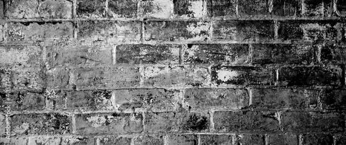 Black gray brick wall background. Monotone texture of a flat brick wall close-up.