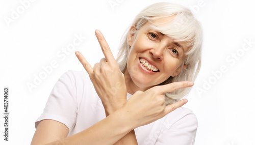 Lifestyle, emotion and people concept: Senior woman wearing casual doing funky action isolated on white background