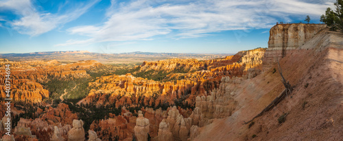 Bryce Canyon National Park amphitheater, panoramic view. Sandstone spires and pine tree forest with beautiful blue sky on background