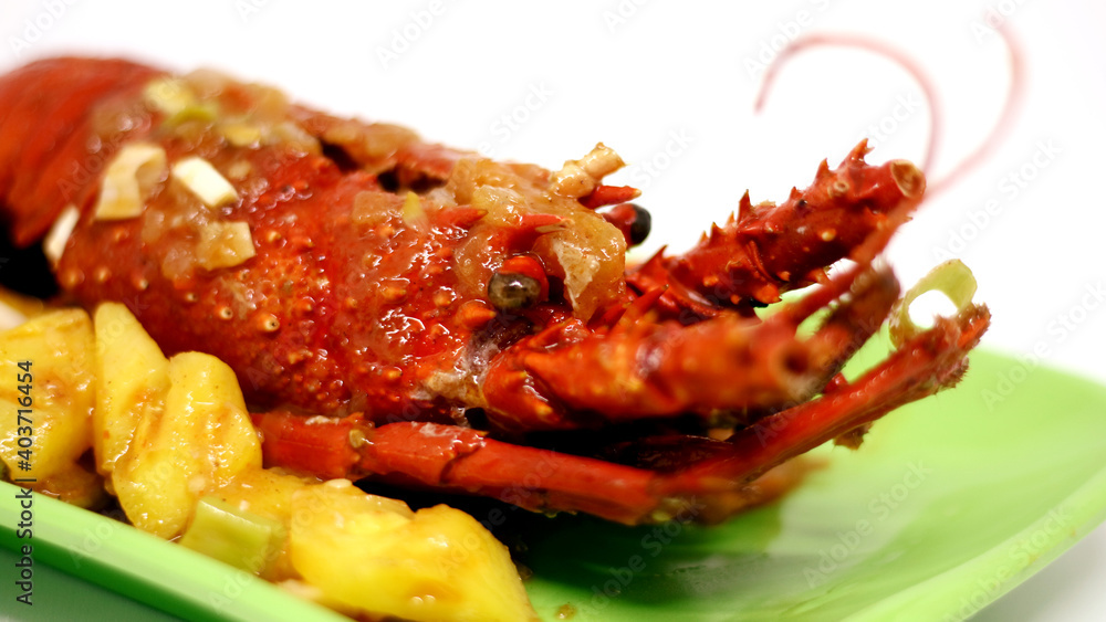 Sweet and sour lobster on green plate. Indonesian food. Sweet and sour lobster on green plate. Indonesian food.