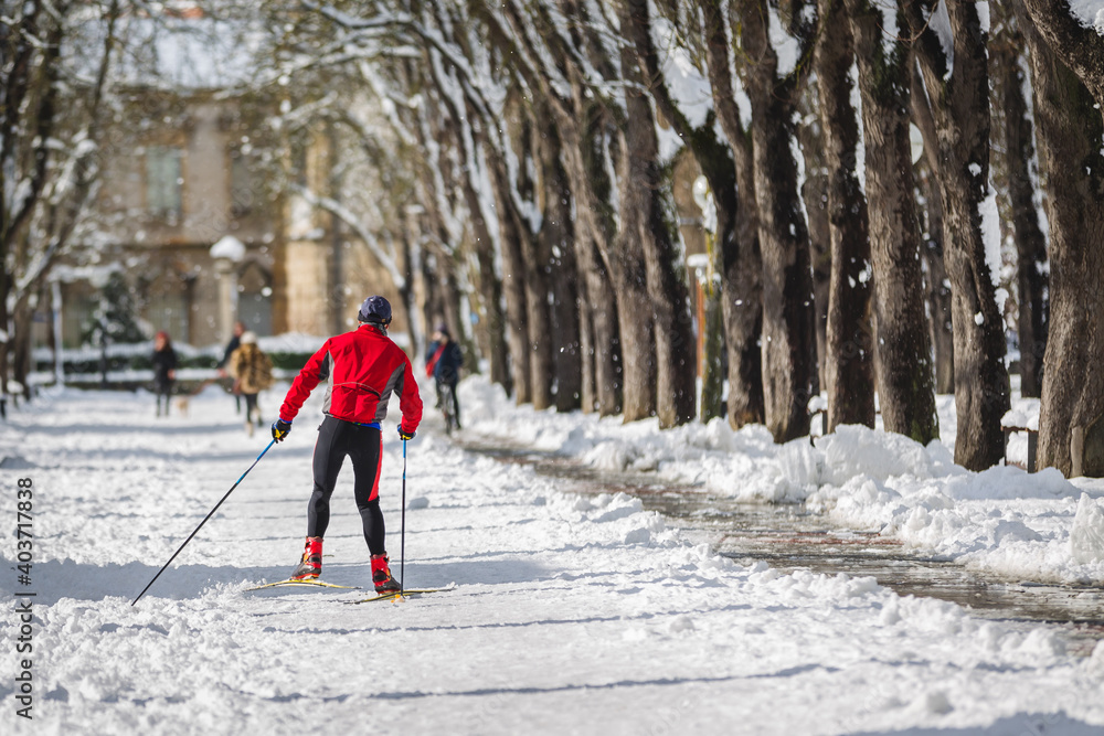 Man skiing in a snowy park in the city