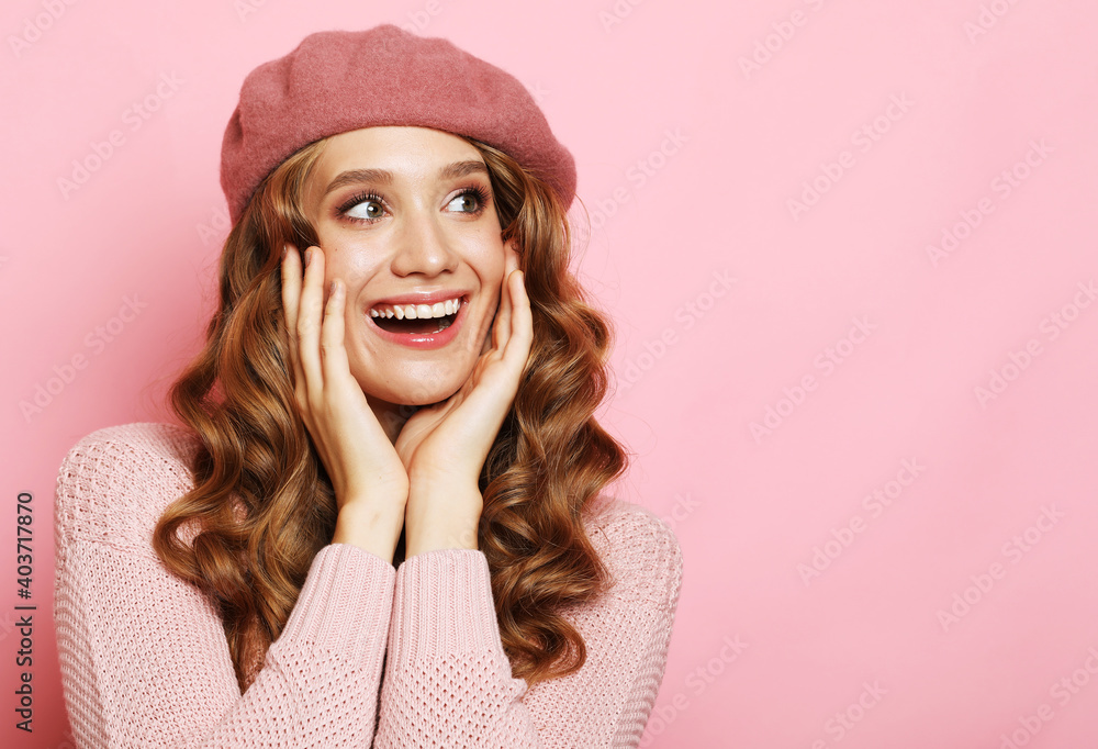 Lifestyle, emotion and people concept: Beautiful young surprised woman wearing pink shirt and beret over pink background Lifestyle, emotion and people concept: Beautiful young surprised woman wearing pink shirt and beret over pink background