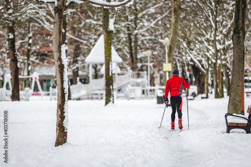 Man skiing in a snowy park in the city