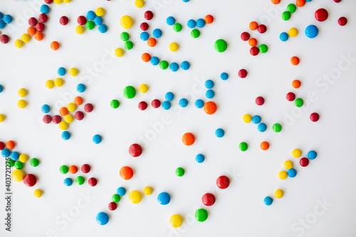 cheerful flat lay white backdrop scene surrounded by rainbow candies