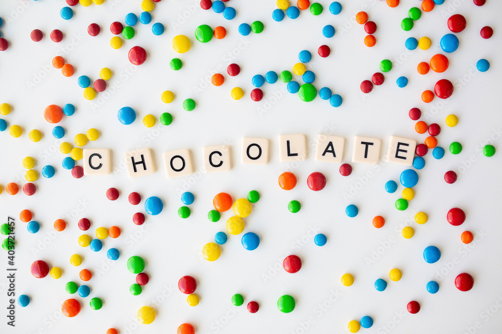 Obraz premium cheerful flat lay white backdrop scene surrounded by rainbow candies
