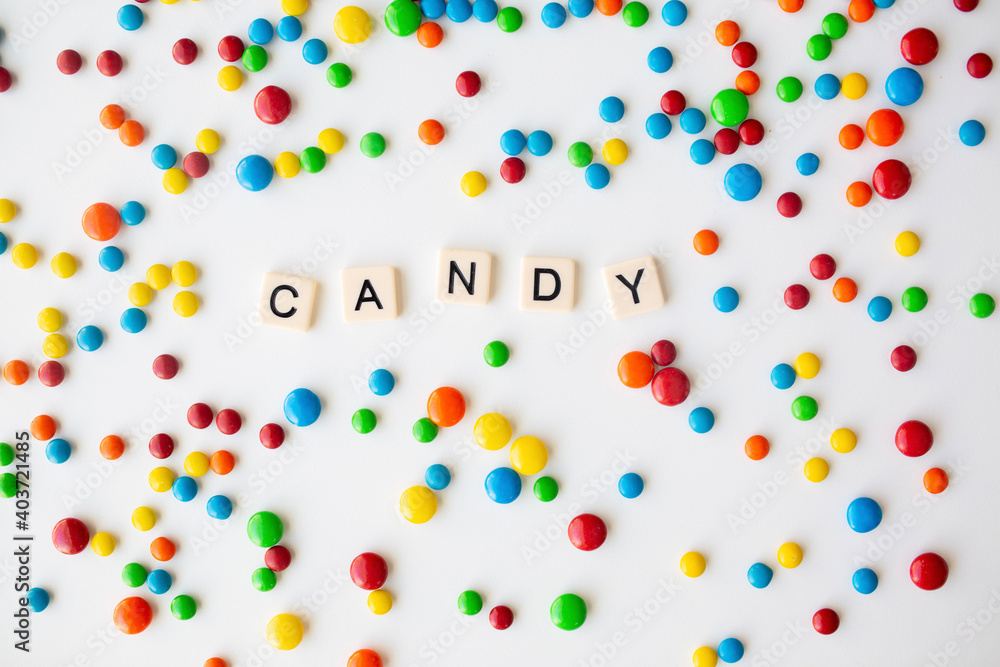 Obraz premium cheerful flat lay white backdrop scene surrounded by rainbow candies