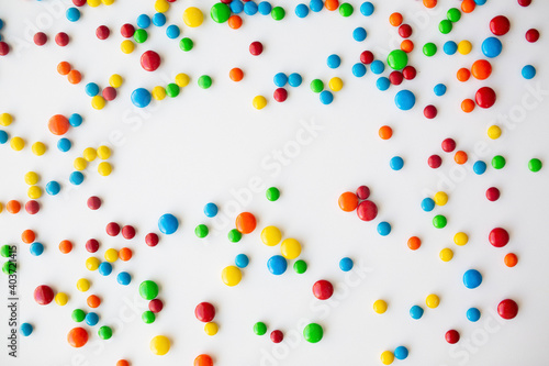 cheerful flat lay white backdrop scene surrounded by rainbow candies