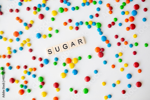 cheerful flat lay white backdrop scene surrounded by rainbow candies