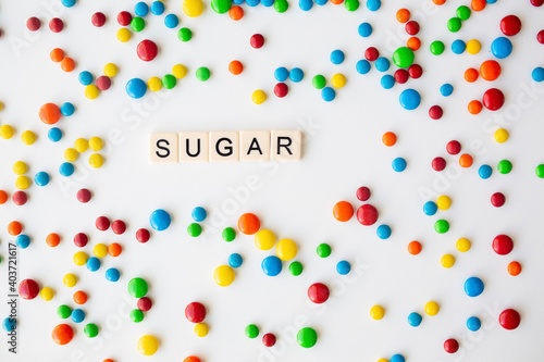 cheerful flat lay white backdrop scene surrounded by rainbow candies