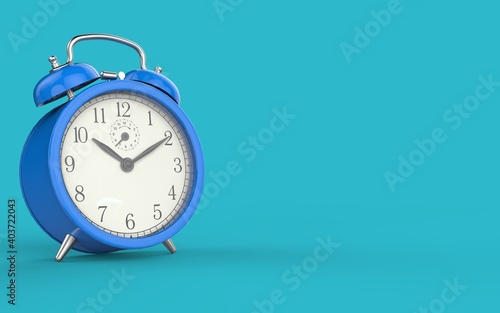 Blue vintage alarm clock on light blue color background