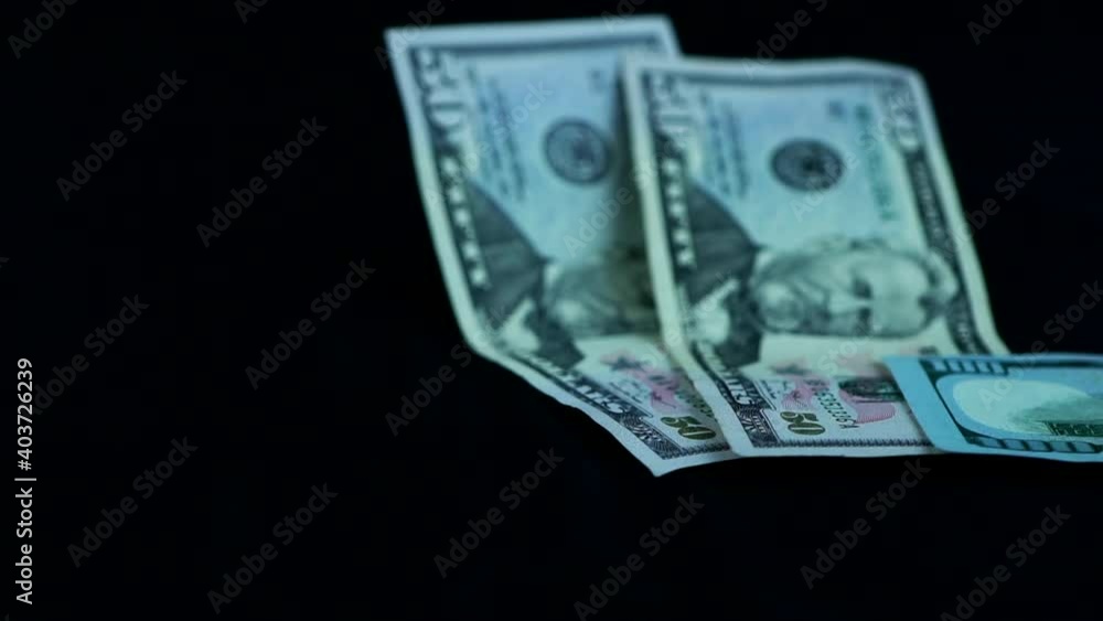 Close Up Of Falling Dollar Bills, studio shot Close Up Of Falling Dollar Bills, studio shot