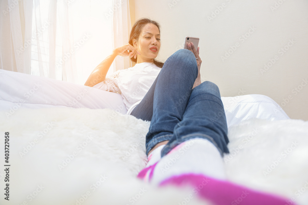 Beautiful black hair woman with red lips in white lace shirt sit by the window. Beautiful black hair woman with red lips in white lace shirt sit by the window.