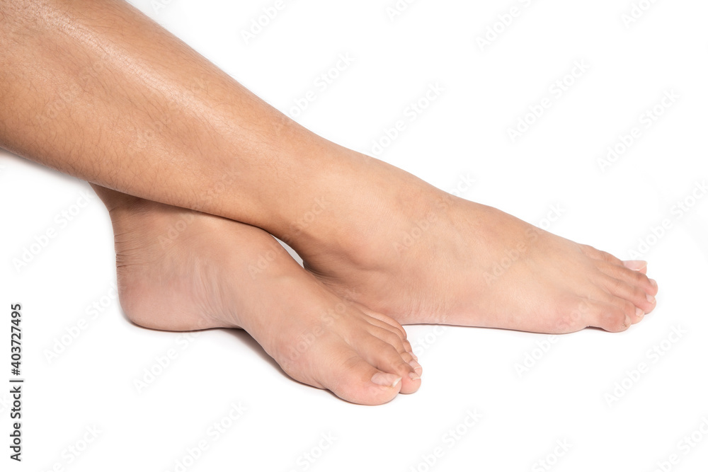 Close up woman feet sitting crossed legs isolated white background