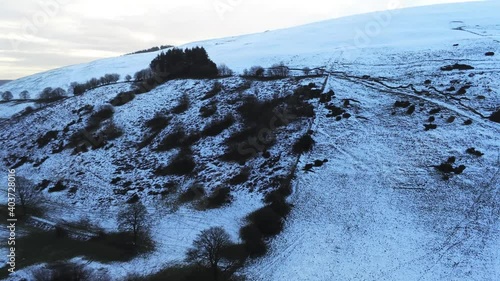 Moel Famau Welsh snowy mountain valley aerial view cold agricultural rural winter landscape slow rising photo