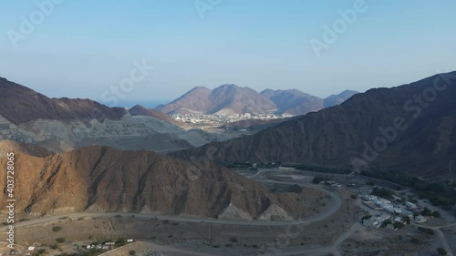 UAE MOUNTAINS:  Top View of Khorfakkan village and mountains, a traditional northern town between the hills. 4k Footage
 photo