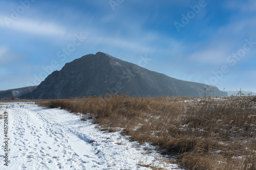 Landscape with a snowy road to the Sister hill. Nakhodka, Russia