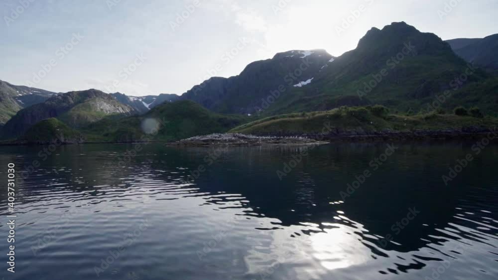 Bright Sky Over Summit With Reflection On Pristine Ocean In Norway. - Static Shot Bright Sky Over Summit With Reflection On Pristine Ocean In Norway. - Static Shot