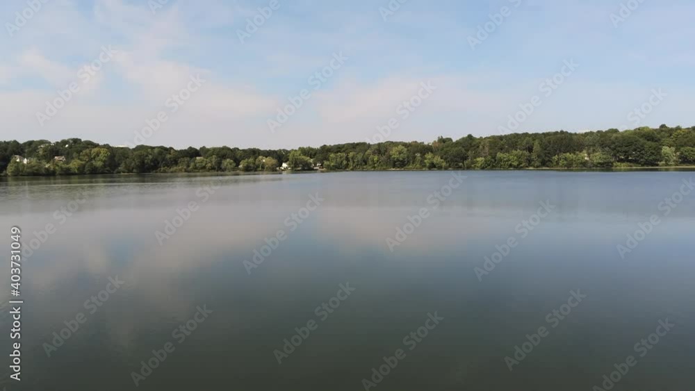 Drone shot of lake water across from forest. Drone shot of lake water across from forest.