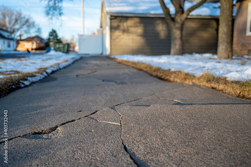 Photos Frost heave crack in residential concrete sidewalk