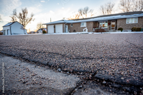 low angle selective focus on asphalt overlay paving on top of a concrete base of a residential street photo