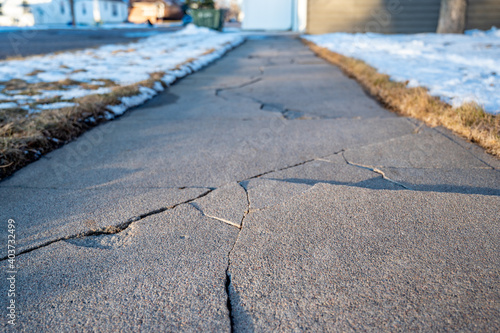 Frost heave crack in residential concrete sidewalk