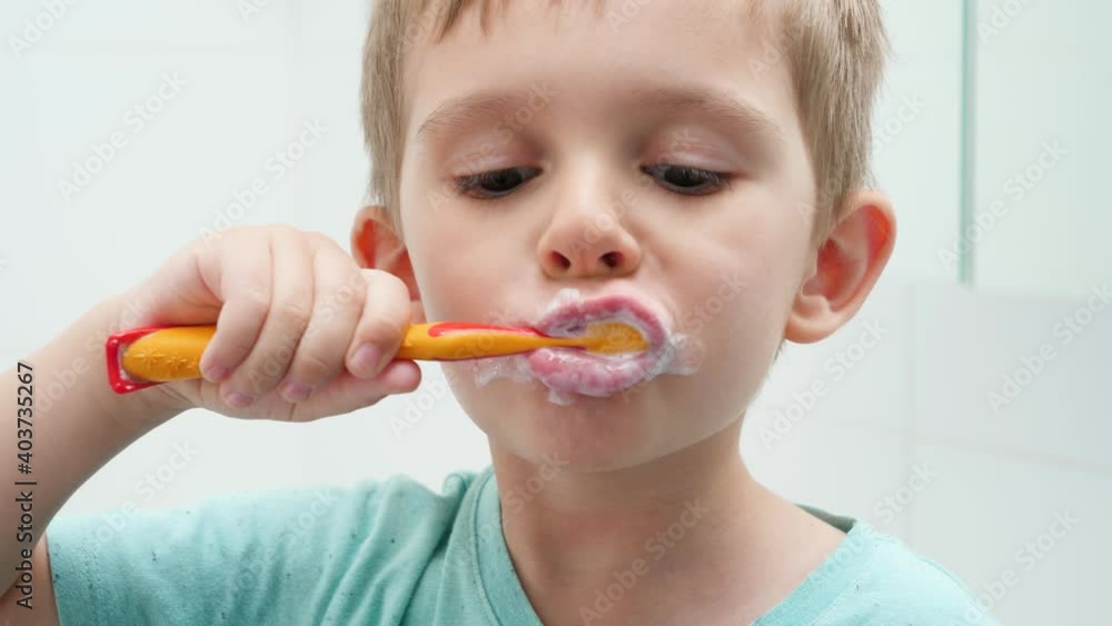 Portrait of funny toddler boy cleaning and brushing teeth at morning. Concept of teeth hygiene and child healthcare Portrait of funny toddler boy cleaning and brushing teeth at morning. Concept of teeth hygiene and child healthcare
