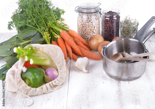 fresh vegetables in a reusable  bag   and dry bean in jar with onions ,garlic...