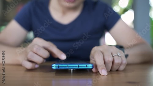 woman using a smartphone while waiting for food at the restaurant photo