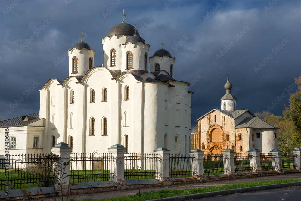 Nikolsky (Nikolo-Dvorishchensky) Cathedral and Church of Paraskeva Friday against the backdrop of a gloomy sky on an October day. Veliky Novgorod, Russia