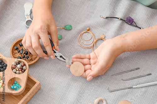 Female designer making jewelry at workplace photo