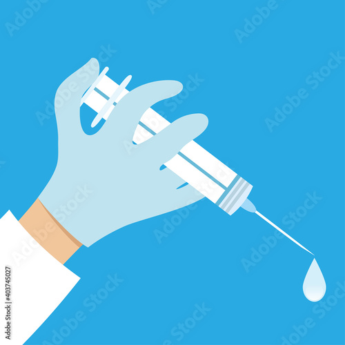 Syringe with vaccine in hand of doctor on blue background.