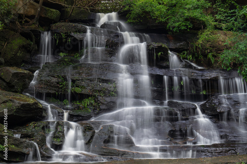 Tall rocky waterfall with good amount of water flowing.