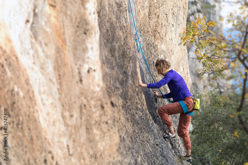 girl climbs a rock-climbing route. outdoor sports.