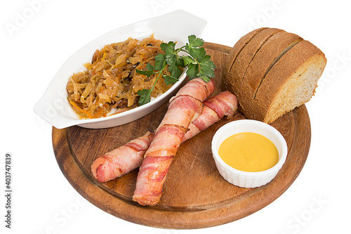 Restaurant serving concept. German, Polish, Austrian cuisine dish, Bigos - cabbage stewed with meat and sausages on a white plate. Close-up. photo