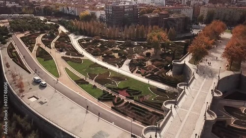 Spain Madrid capital drone shot aerial look view from above city Puente de Toledo Bridge bush art ornaments flying up park sunny day
