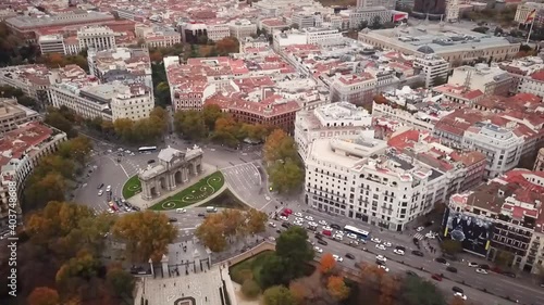 Spain Madrid capital drone shot aerial look view from above city traffic cars flying towards pan left Puerta de Alcala monument 