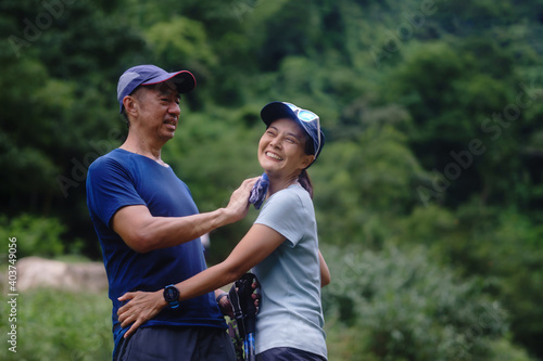 Asian middle-aged couple Are relaxing while hiking on vacation