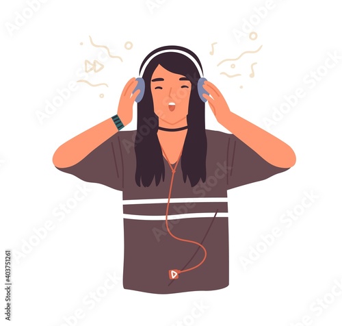 Hipster teenage girl singing and listening to music in headphones, using mp3 ...