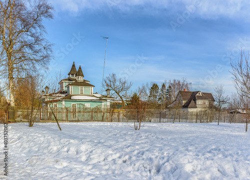 Rural landscape with wooden houses in winter