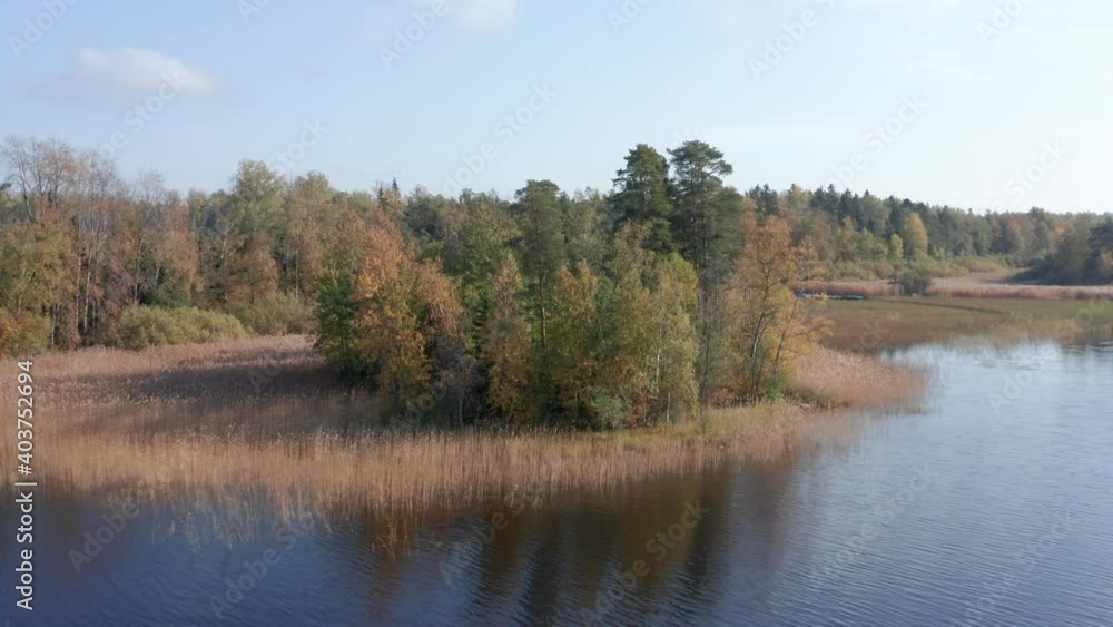 Drone flight over a picturesque autumn lake in Karelia, Russia, an island in Lake Vuoksa Drone flight over a picturesque autumn lake in Karelia, Russia, an island in Lake Vuoksa
